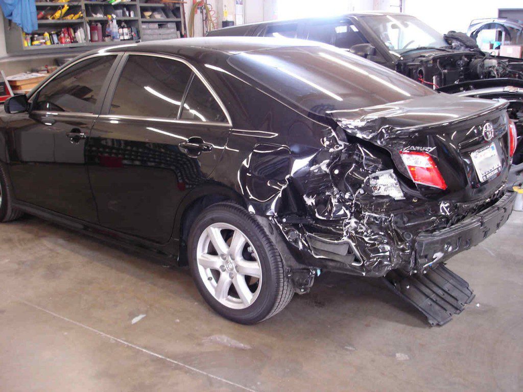 Body Shop with a Toyota Car  That Has Damage to Its Back End